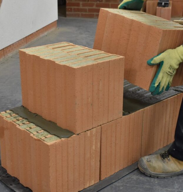 Insulated clay Porotherm blocks being installed in stretcher bond.