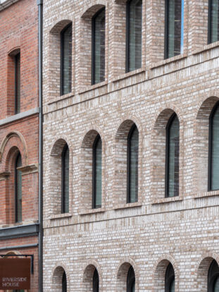 Buff arch bricks and coping bricks supplied to Riverside House, Salford.