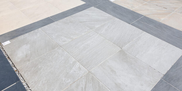 A patio space using light grey, dark grey and cream porcelain slabs.