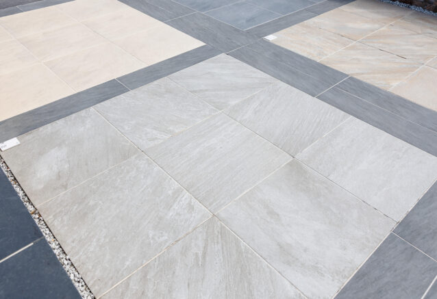 A patio space using light grey, dark grey and cream porcelain slabs.