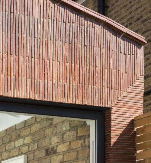 Stacked creasing tiles clad new extension in London 1