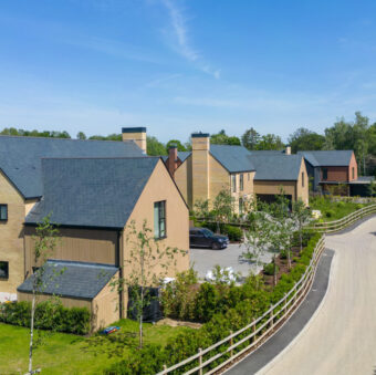 A view of a modern housing development on a quiet, private road on a sunny day