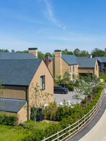 A view of a modern housing development on a quiet, private road on a sunny day
