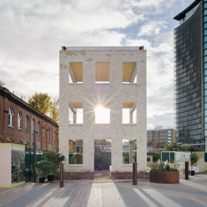 An image of a hollowed out building, constructed to show the internal structure. Made from stone bricks.