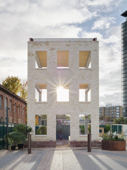 An image of a hollowed out building, constructed to show the internal structure. Made from stone bricks.