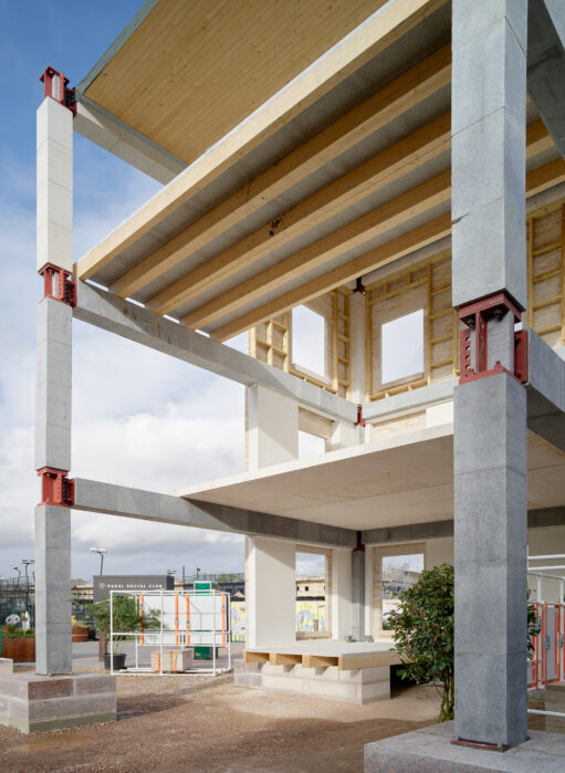 A building in construction, with exposed framework that demonstrates its use of stone.