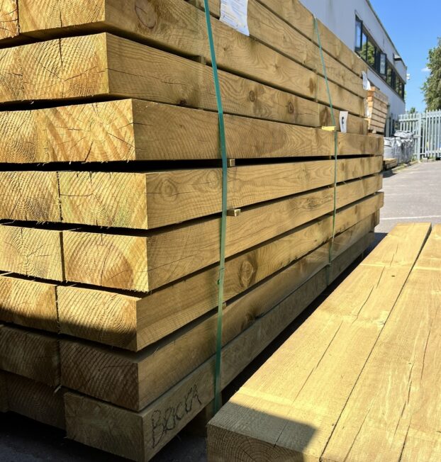 A stack of timber sleepers, photographed on a sunny day