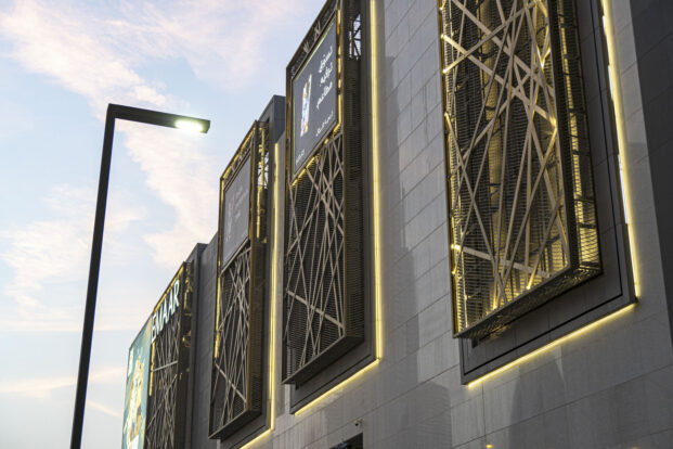 Mesh cladding facade with light accents