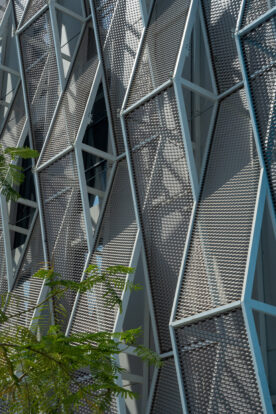 Geometric silver and blue mesh cladding facade