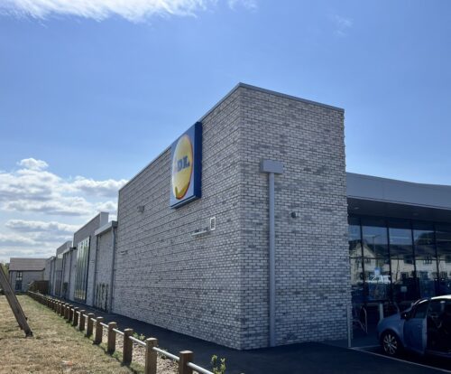 A Lidl supermarket with modern, light grey brick facade.