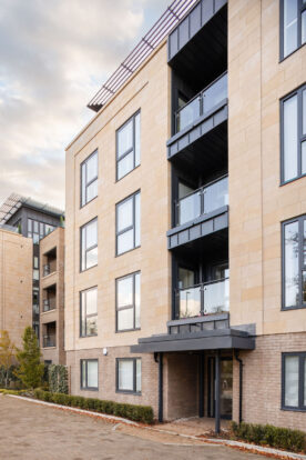 Buff brick and stone apartment block.