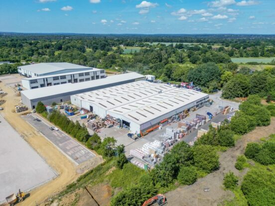 An aerial view of a builders merchants under a blue sky.