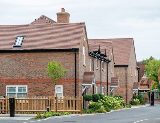 A row of brick houses along a quiet street.