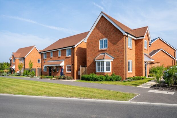 Group of new red-brick houses on a sunny day.