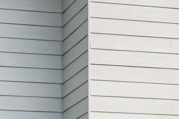 A close up view of white Hardie Plank panels on a building.