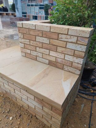 close up on white and pink stone brick benches with stone slab seating