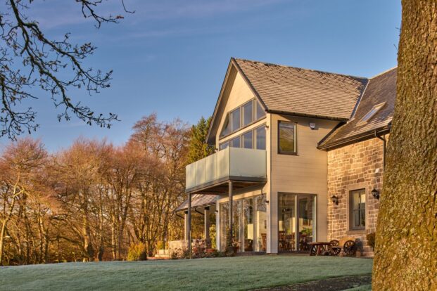 A Large stone and timber house on a frosty day.