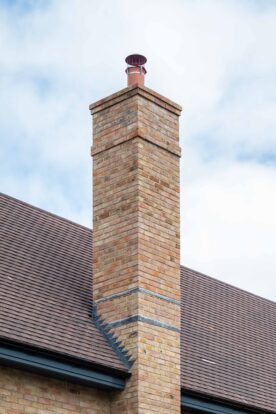 Prefabricated chimney with red and yellow facing bricks in Hayfield Crescent