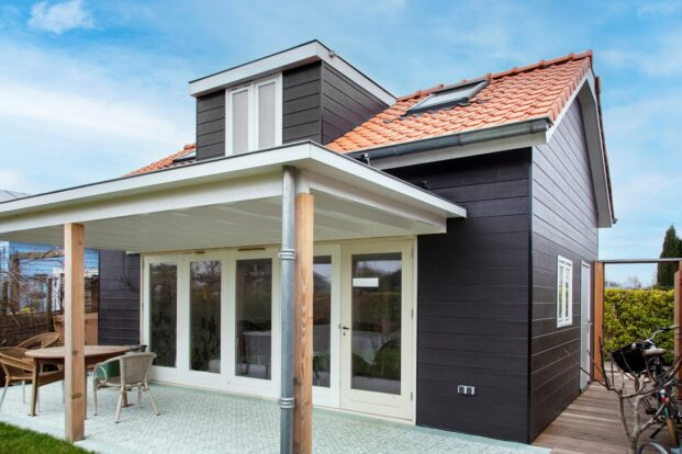 A holiday cabin with dark plank walls.
