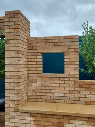 warm buff bricks made of stone with square window shape cut out