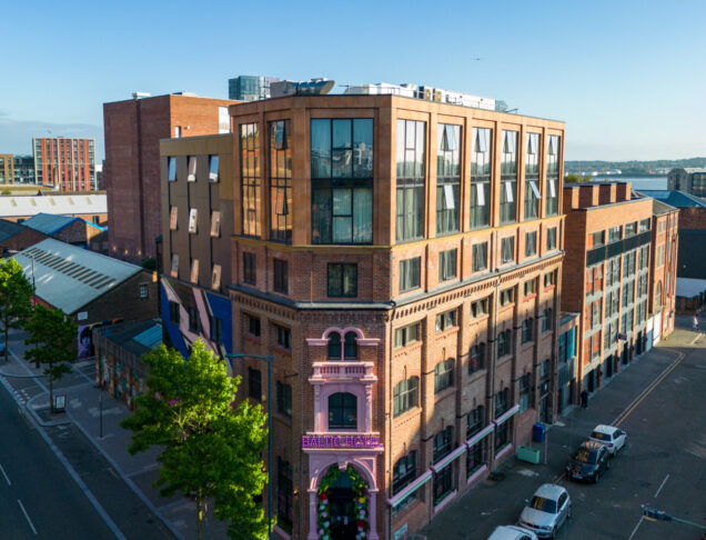 A hotel with a red brick and Scalamid facade.