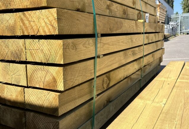 A stack of timber sleepers, photographed on a sunny day