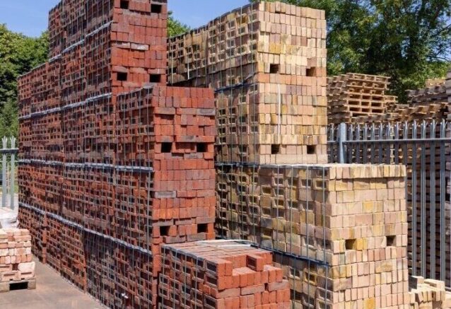 Two rows of stacked red and buff brick palettes.