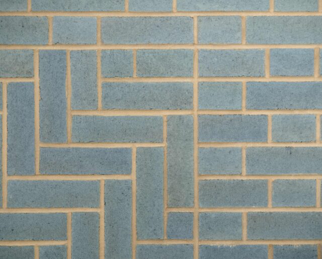 A herringbone pattern made from blue bricks.