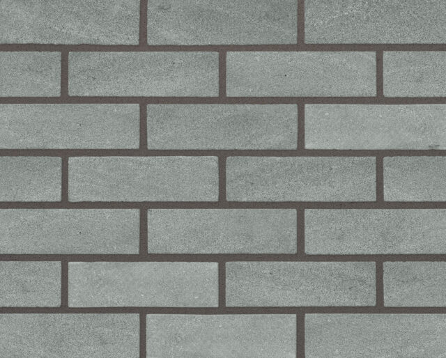 A close up image of a grey green brick wall.