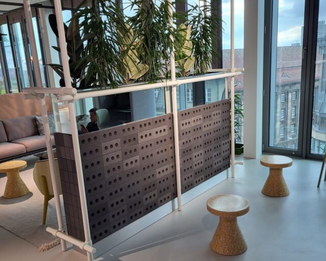 A feature dark grey brick wall in a modern indoor space.