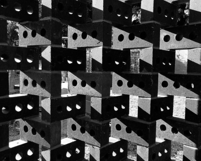 A decorative pattern made from dark grey bricks.