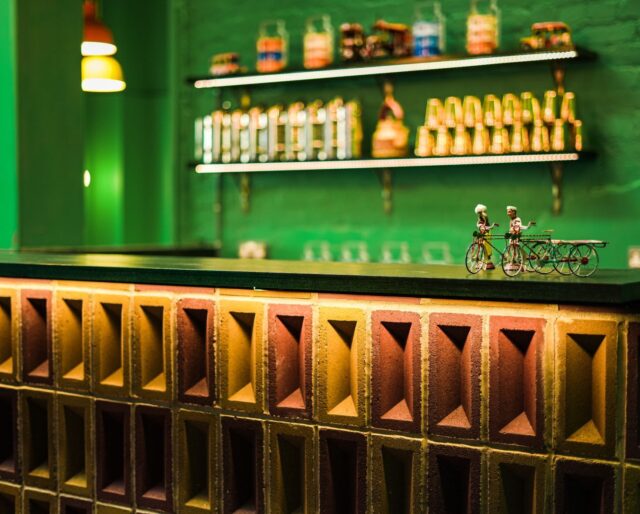 A bar made from pink and yellow bricks, turned upright so that the frogs are visible and become a design feature.