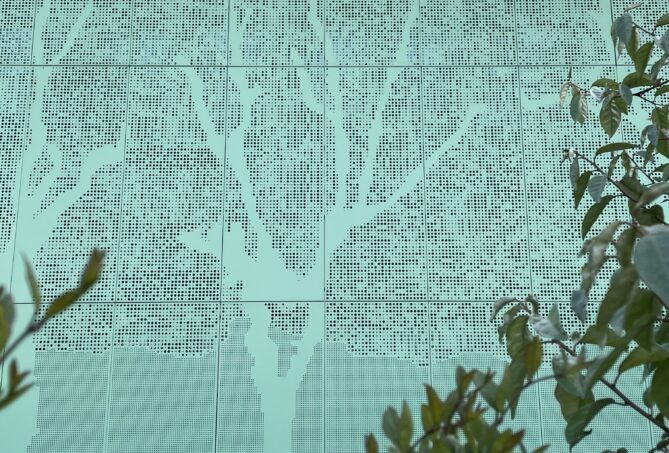Tree detail in perforated metal cladding
