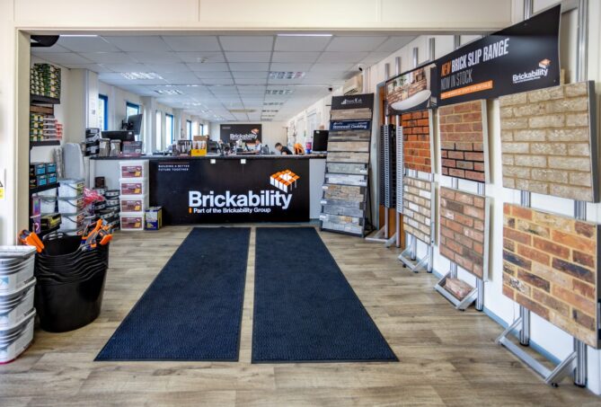 A photo of a builders merchants with bricks displays and building materials.
