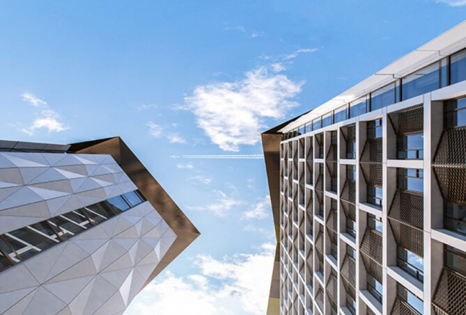 Silver metal cladding and bronze expanded mesh on high-rise project.