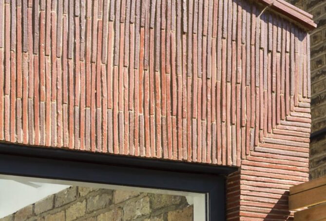 Stacked creasing tiles clad new extension in London 1