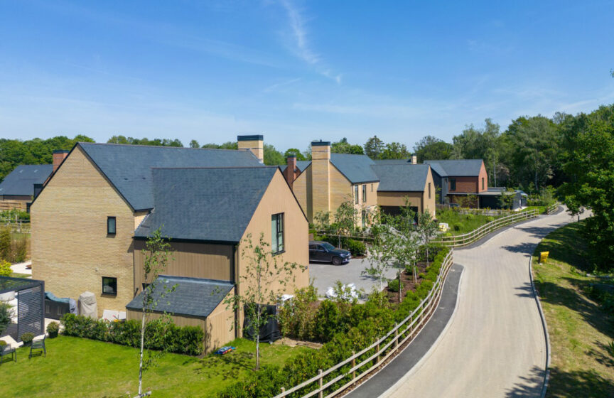 A view of a modern housing development on a quiet, private road on a sunny day